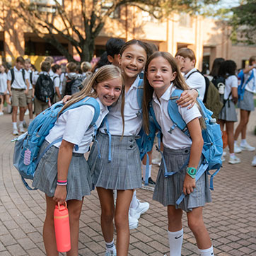 Three students smiling. Links to Tangible Personal Property