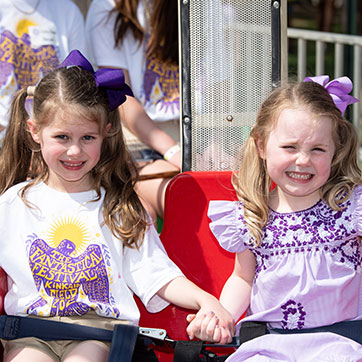 Two girls smiling. Links to Gifts of Appreciated Securities